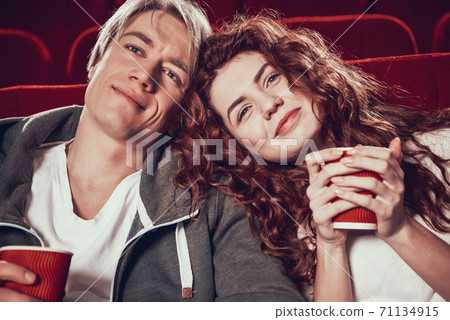 Red haired girl with boyfriend watching movie.  71134915