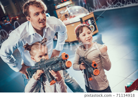 Two girls stand in an entertainment center. Two girls stand in an entertainment center. 71134918