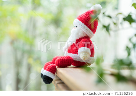 Santa Claus amigurumi sitting on window furniture 71136256