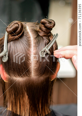 Hair clips on hair of young woman Hair clips on hair of young woman 71136395