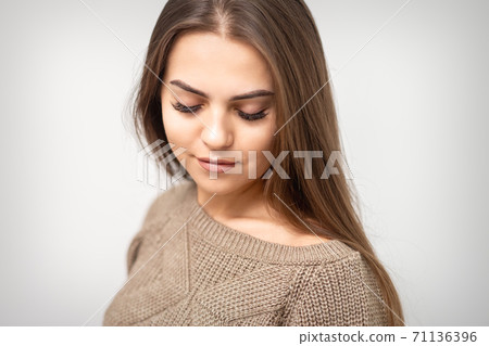 Woman with closed eyes after cosmetic procedure 71136396
