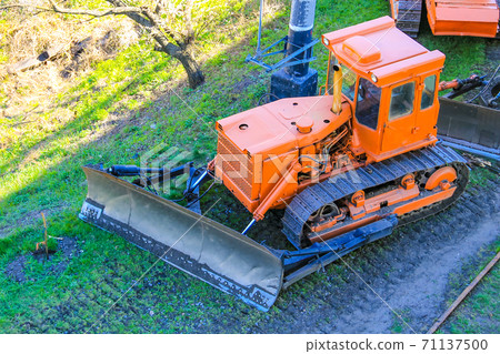 Orange heavy bulldozer at the construction site Orange heavy bulldozer at the construction site 71137500