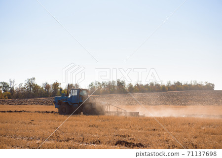 Farmer preparing his field in a tractor ready for spring. Farmer preparing his field in a tractor ready for spring. 71137698