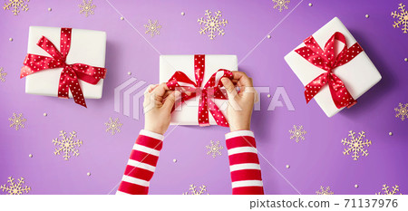 Person making Christmas gift boxes Person making Christmas gift boxes 71137976