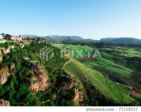 Panoramic view at gorge and valley of New bridge in Ronda, one of the famous place in Andalucia. Andalusia, Spain Panoramic view at gorge and valley of New bridge in Ronda, one of the famous place in Andalucia. Andalusia, Spain 71138557