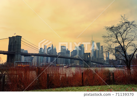 view of a famous suspended Brooklyn Bridge and Manhattan skyscrapers in New York view of a famous suspended Brooklyn Bridge and Manhattan skyscrapers in New York 71139370