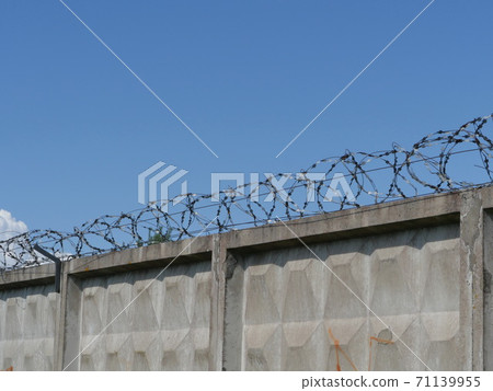 high fence with barbed wire high fence with barbed wire 71139955