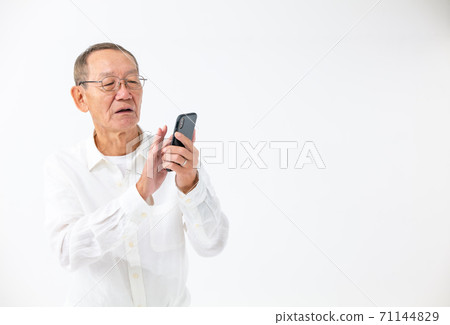 Senior men watching smartphones Senior men watching smartphones 71144829