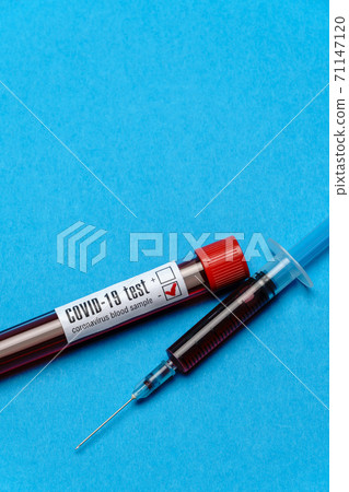 Syringe And Plastic Test Tube With Blood Sample over blue background with copyspace Syringe And Plastic Test Tube With Blood Sample over blue background with copyspace 71147120
