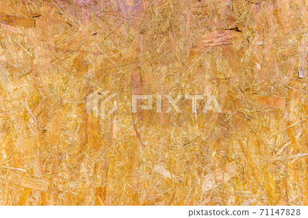 OSB are made of brown wood chips, ground into a wooden background. Top view of OSB wood veneer, dense, seamless surfaces. 71147828