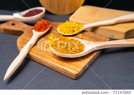 spices in a wooden bowl close-up on a brown wooden background. selective focus spices in a wooden bowl close-up on a brown wooden background. selective focus 71147860