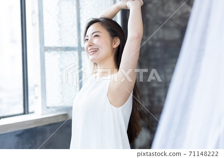 Beauty image of a woman who raises her hand and takes a deep breath 71148222