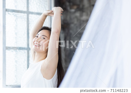 Beauty image of a woman who raises her hand and takes a deep breath 71148223
