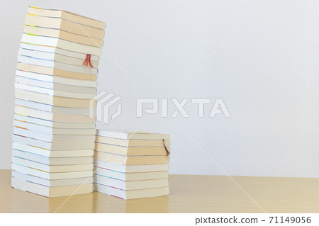 Many books stacked on the desk Many books stacked on the desk 71149056