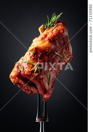 Grilled pork ribs on a fork. Grilled pork ribs on a fork. 71150980