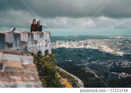 Two young women contemplating the landscape from Palacio da Pena in Sintra, Portugal 71151749
