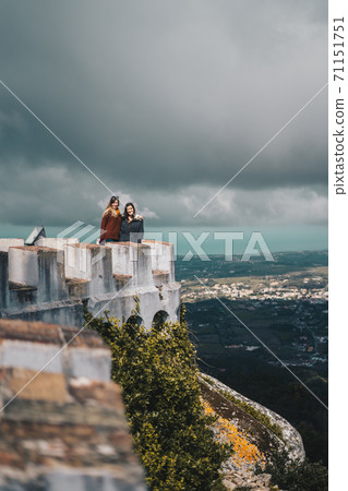 Two young women contemplating the landscape from Palacio da Pena in Sintra, Portugal 71151751
