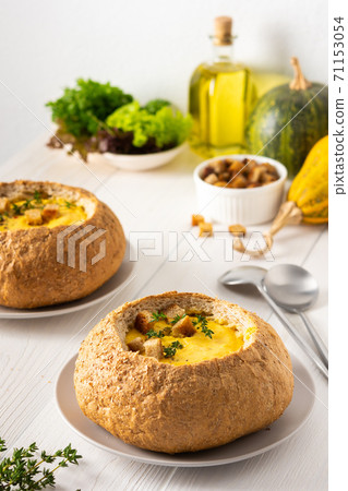 Pumpkin puree soup in a plate of bread Pumpkin puree soup in a plate of bread 71153054
