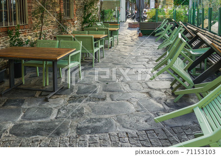 Empty outdoors tables as Coronavirus measures affect business & life in Greece. Empty outdoors tables as Coronavirus measures affect business & life in Greece. 71153103