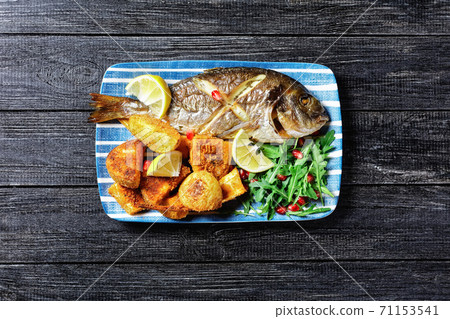 Roasted dorado with potato and wild rocket salad Roasted dorado with potato and wild rocket salad 71153541