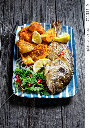 Roasted dorado with potato and wild rocket salad 71153549