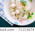 Clear Pork Noodle Soup Topped with pork balls Garnish with fried garlic and cilantro 71153674