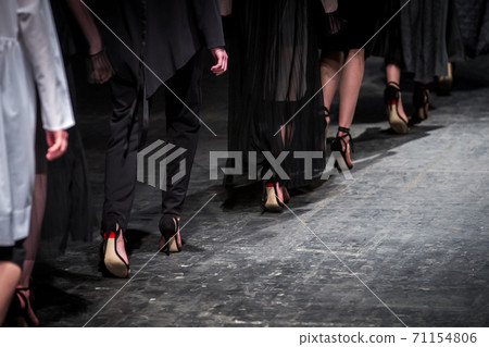Fashion model on a runway during the fashion show. Fashion week themed photograph. 71154806