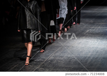 Fashion model on a runway during the fashion show. Fashion week themed photograph. 71154808