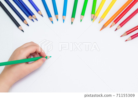 Kid is drawing on white blank paper. 71155309