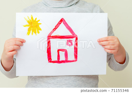 Child holding picture of house. 71155346