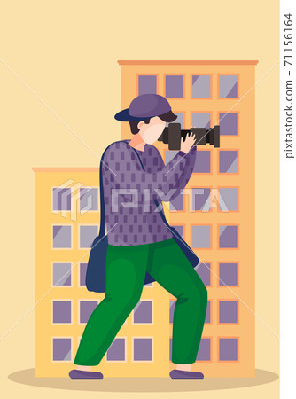 The guy standing and adjusting the lens. Photographer with camera takes pictures of a building 71156164