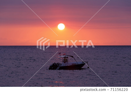 Sunset over Madagascar Nosy be beach with boat silhouette 71156220