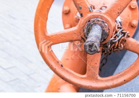 orange iron valve for regulating water flow vertical close-up 71156700