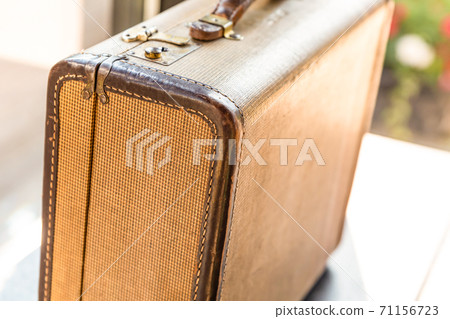 beige vintage suitcase closeup, horizontally focuses on the foreground 71156723