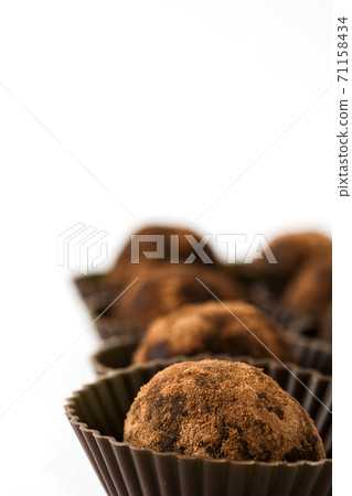 Delicious chocolate truffles with cocoa dusted isolated on white background Delicious chocolate truffles with cocoa dusted isolated on white background 71158434