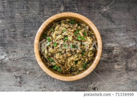 Baba ganoush in wooden bowl on wooden table. Top view Baba ganoush in wooden bowl on wooden table. Top view 71158490