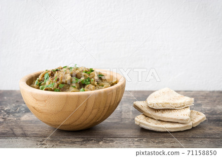 Eggplant baba ganoush on wooden table Eggplant baba ganoush on wooden table 71158850