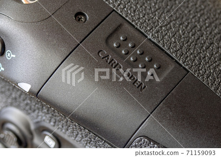The slot of memory card in a digital camera. The closed door of data card of the digital camera. The slot of memory card in a digital camera. The closed door of data card of the digital camera. 71159093