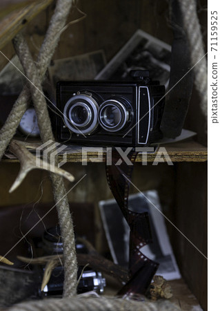 Vintage film camera and old photographs in the old, wooden crate 71159525