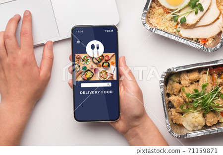Lunch at work and modern delivery. Guy choosing food in mobile application on smartphone screen 71159871