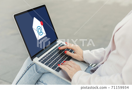 Businesswoman With Laptop Reading E-Mail Message Communicating Online Sitting Outdoors Businesswoman With Laptop Reading E-Mail Message Communicating Online Sitting Outdoors 71159934