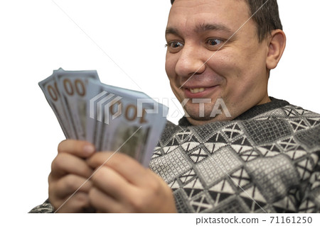 abnormal, crazy face of a man who holds money 71161250