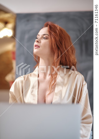 Relaxed woman working from home on her laptop Relaxed woman working from home on her laptop 71161346