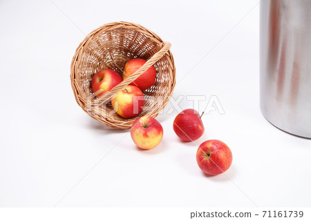 Image of scattered red apples with wicker basket 71161739