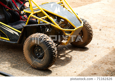 Muddy Buggy Parked in the Parking Lot After a Heavy Dirt Race. Muddy Buggy Parked in the Parking Lot After a Heavy Dirt Race. 71162826