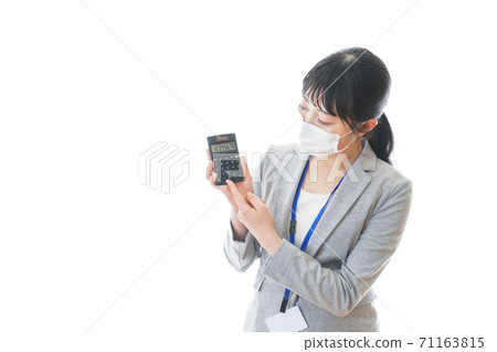 A young business person wearing a mask and holding a calculator A young business person wearing a mask and holding a calculator 71163815