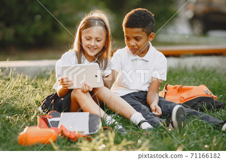 Little african boy study with caucasian girl Little african boy study with caucasian girl 71166182