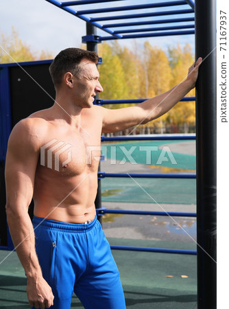 middle age shirtless man resting after outdoors workout 71167937