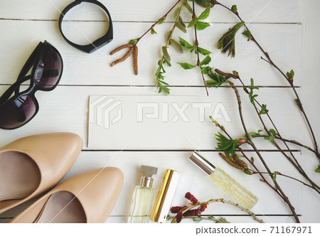 woman accessories and spring green leaves. woman accessories and spring green leaves. 71167971