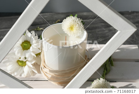 Organic scented soy candle on white wooden rack. 71168017